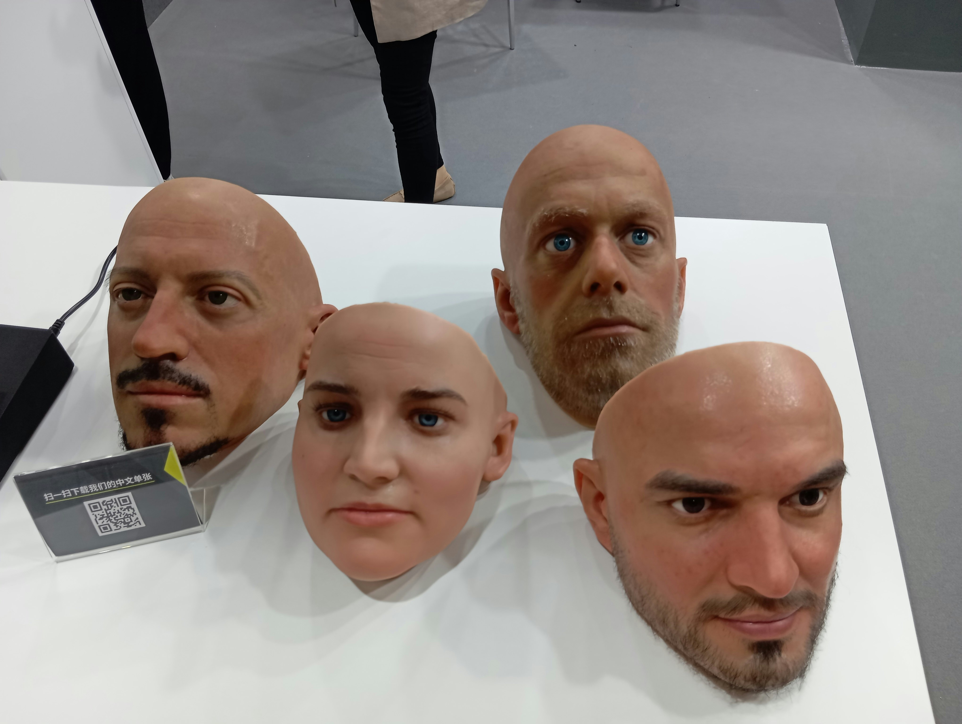group of people with bald heads on display